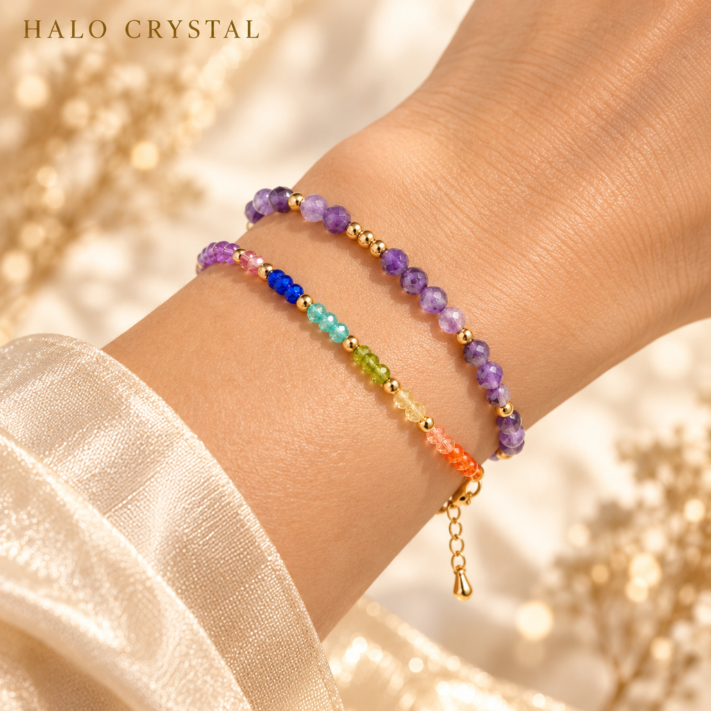Seven chakra gemstone bracelet stacked with an amethyst faceted gemstone bracelet on wrist